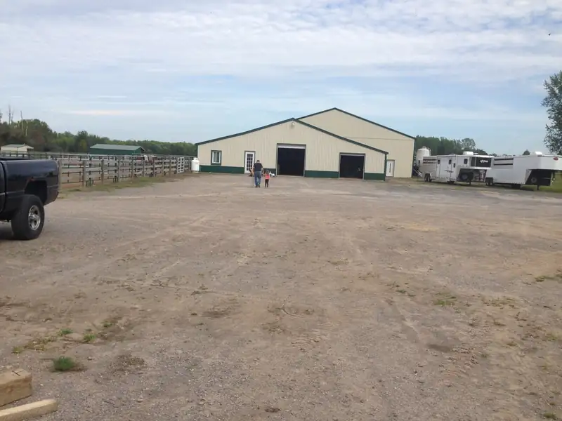 The gravel drive leading up to the main barn